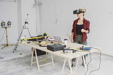 Image showing Woman using virtual reality goggles in workshop 