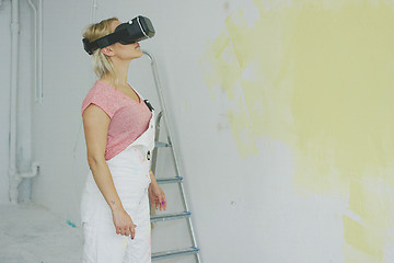 Image showing Female in overalls using virtual reality headset