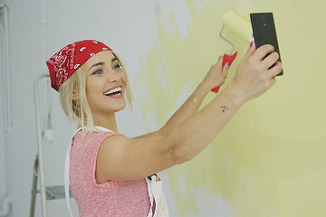 Image showing Painting wall woman taking selfie