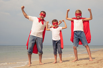 Image showing Father and children playing superhero on the beach at the day ti