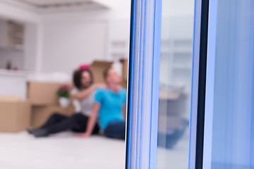 Image showing young  gay couple moving  in new house