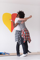 Image showing couple with painted heart on wall