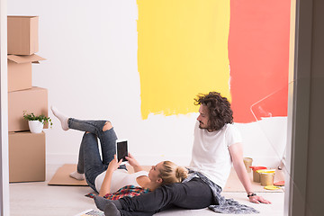 Image showing Happy young couple relaxing after painting