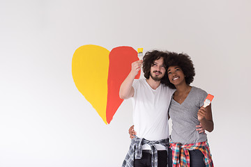 Image showing couple with painted heart on wall