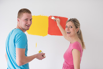 Image showing couple painting interior wall