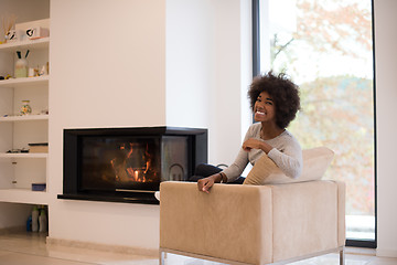 Image showing black woman in front of fireplace