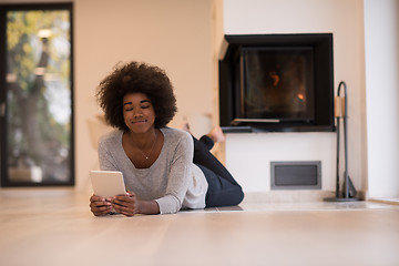 Image showing black women using tablet computer on the floor