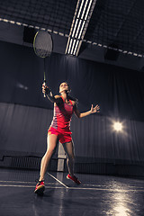 Image showing Young woman playing badminton at gym