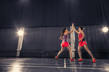 Image showing Young women playing badminton at gym