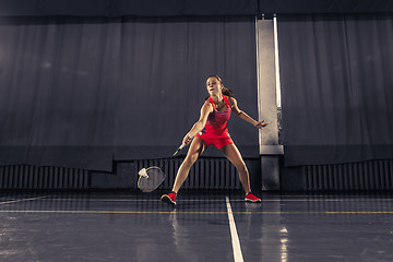 Image showing Young woman playing badminton at gym