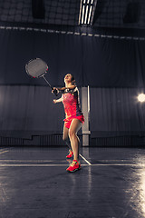 Image showing Young woman playing badminton at gym