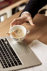 Image showing Coffee in white cup spilling on the table in the morning working day at office table