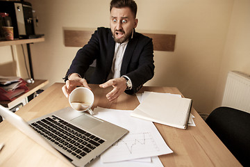 Image showing Coffee in white cup spilling on the table in the morning working day at office table