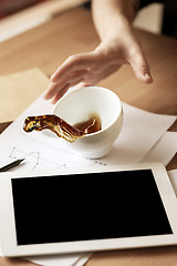 Image showing Coffee in white cup spilling on the table in the morning working day at office table