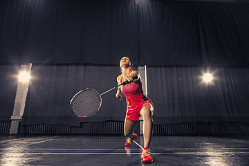 Image showing Young woman playing badminton at gym