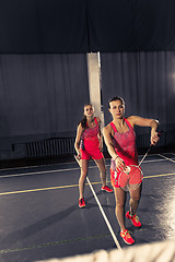 Image showing Young women playing badminton at gym