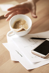 Image showing Coffee in white cup spilling on the table in the morning working day at office table