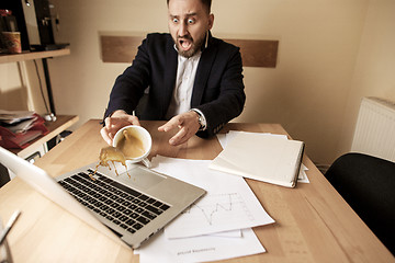 Image showing Coffee in white cup spilling on the table in the morning working day at office table