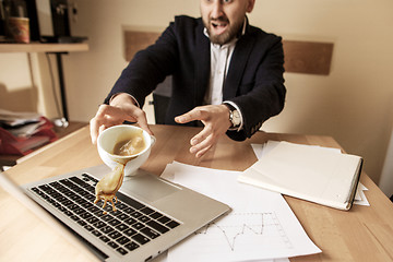 Image showing Coffee in white cup spilling on the table in the morning working day at office table