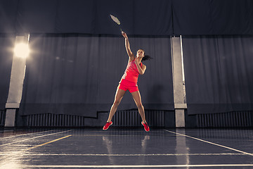 Image showing Young woman playing badminton at gym