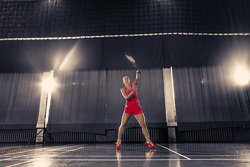 Image showing Young woman playing badminton at gym