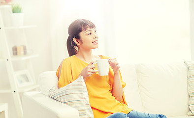 Image showing happy asian woman drinking from tea cup