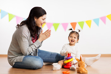 Image showing mother and baby daughter playing with pyramid toy