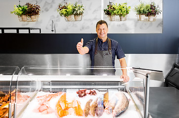 Image showing seafood seller at fish shop showing thumbs up