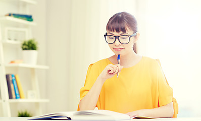 Image showing happy asian young woman student learning at home