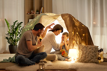 Image showing father telling scary stories to his daughter