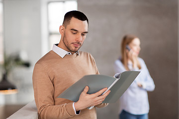 Image showing male office worker with folder