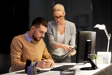 Image showing business team with tablet pc work at night office