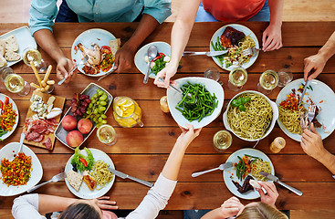 Image showing group of people eating at table with food