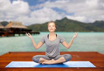 Image showing woman making yoga in and meditating lotus pose