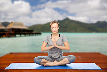 Image showing woman making yoga in and meditating lotus pose