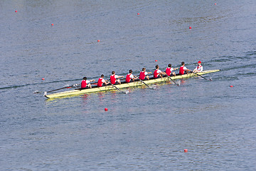 Image showing Rowers in eight-oar rowing boats on the tranquil lake