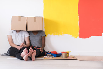 Image showing young multiethnic couple playing with cardboard boxes