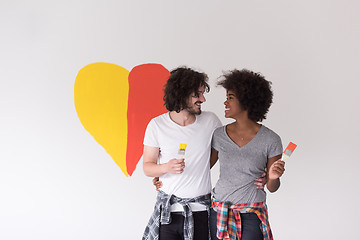 Image showing couple with painted heart on wall