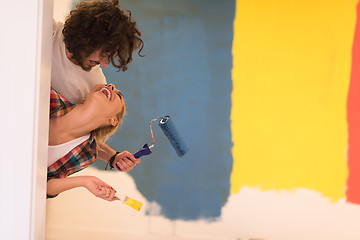 Image showing portrait of a couple painting interior wall