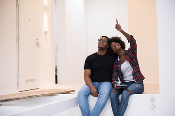 Image showing couple having break during moving to new house