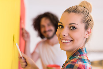 Image showing couple painting interior wall