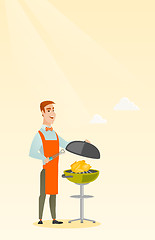 Image showing Man cooking chicken on barbecue grill.