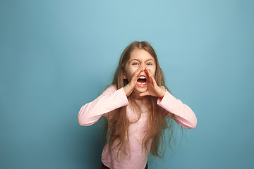 Image showing The cry. Teen girl on a blue background. Facial expressions and people emotions concept