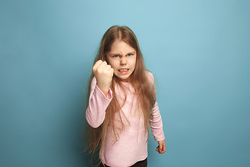 Image showing The threat. Teen girl on a blue background. Facial expressions and people emotions concept