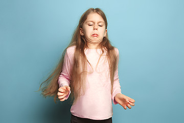 Image showing The disgust. Teen girl on a blue background. Facial expressions and people emotions concept