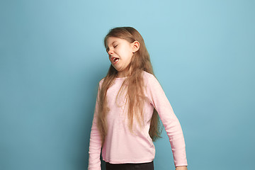 Image showing The disgust. Teen girl on a blue background. Facial expressions and people emotions concept