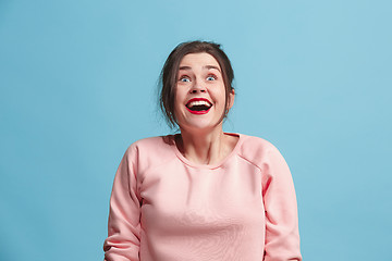 Image showing Beautiful woman looking suprised isolated on blue