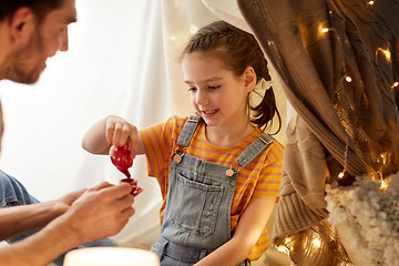 Image showing family playing tea party in kids tent at home