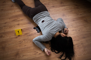 Image showing dead woman body in blood on floor at crime scene