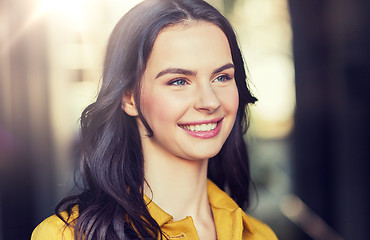 Image showing smiling young woman in city